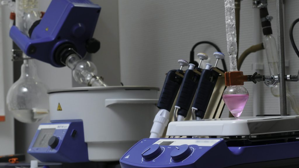 Equipment in chemical laboratory with rotating flasks. Stock footage. Rotating equipment and colored