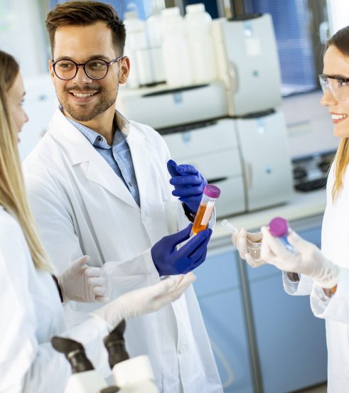 Group of young researchers analyzing chemical data in the laboratory Group of young researchers analyzing chemical data in the laboratory